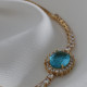 Oval Mavi Zircon Taşlı Anturaj Gold Renk Su Yolu Asansörlü Bileklik